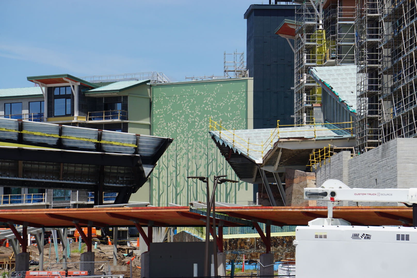 A new bridge, additional tree murals, and dark green tower finishes are among the latest additions to Disney Lakeshore Lodge.