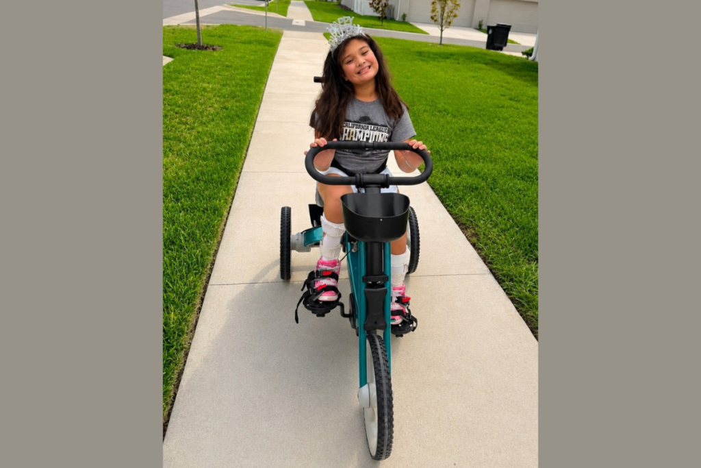 Riley takes her new tricycle out for a spin.