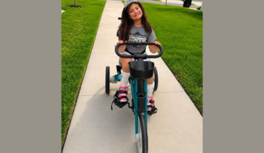 Riley takes her new tricycle out for a spin.