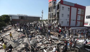 Residents and rescue workers search through the rubble of a collapsed building after an earthquake struck Cali, Colombia, Monday, Aug. 10, 2026. (AP Photo/Santiago Saldarriaga)