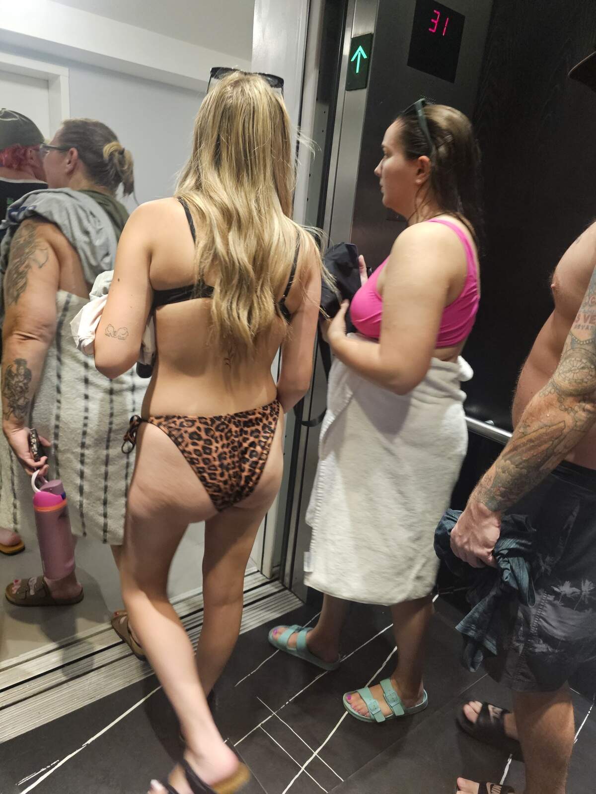 Tourists at The Club at Brickell Bay leave one of the elevators on Aug. 15, 2026, where about 80 percent of the units are rented through Airbnb and other vacation booking sites, in violation of the city’s ban on short-term rentals in multifamily buildings.