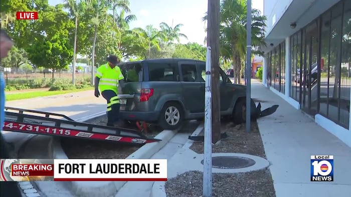 2-vehicle crash leaves car on its side, another against Fort Lauderdale building