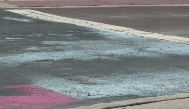 Covered St. Pete Pride mural peaks through black paint on Central Avenue