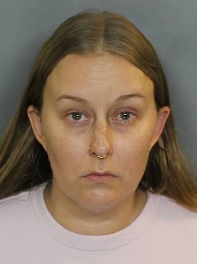 Mugshot of a woman with long light brown hair and a nose ring.
