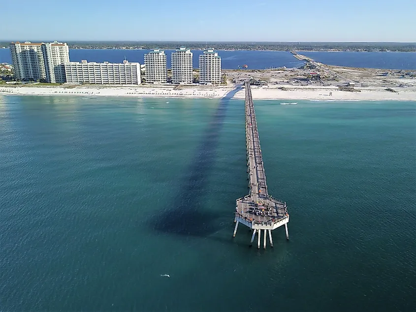 Aerial view of the Navarre Beach Fishing Pier reaching into the Gulf