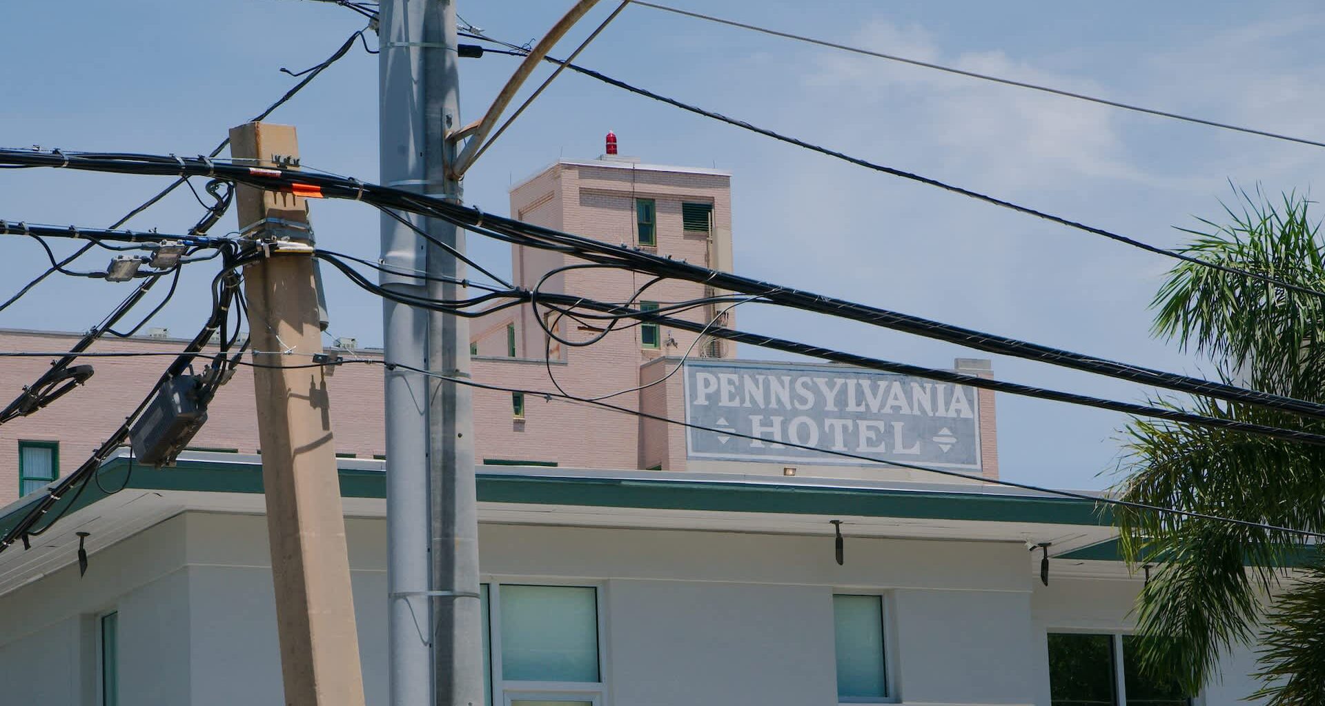 A hotel building with the name "Pennsylvania Hotel" visible among utility poles and wires.