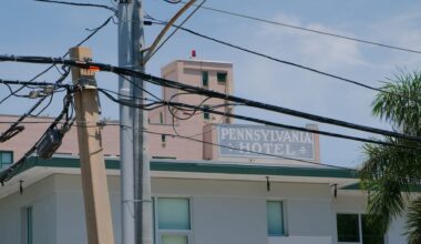 A hotel building with the name "Pennsylvania Hotel" visible among utility poles and wires.