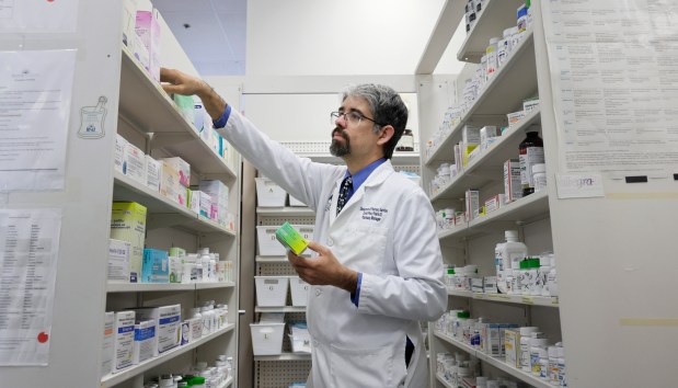 Pharmacist Dr. David Pino checking medications at the University Pharmacy in Davie on Friday, August 21, 2026. (Carline Jean/South Florida Sun Sentinel)