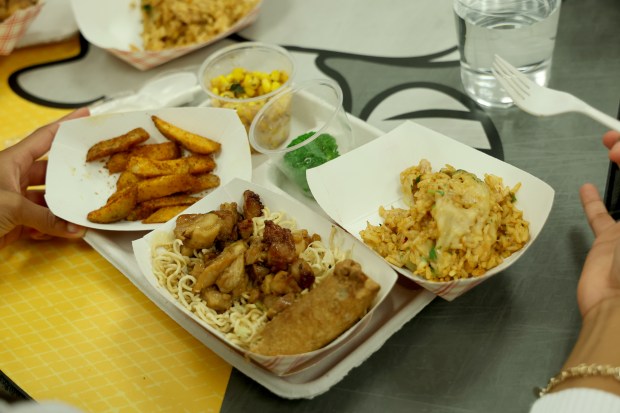 New school lunch menu items include cajun fries, chicken lo mein with vegetable eggroll, street corn and arroz con pollo. The foods were offered during an event Tuesday at South Broward High School in Hollywood. (Amy Beth Bennett / South Florida Sun Sentinel)