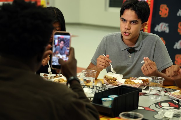 Senior Andre Rua, 17, gives an interview Tuesday as he tastes dishes during an event held to announce new lunch menu items for Broward County schools. (Amy Beth Bennett / South Florida Sun Sentinel)