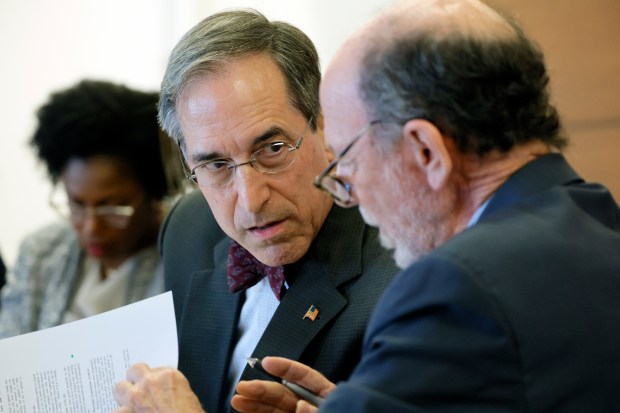 Benedict Kuehne, attorney for Deerfield Beach mayoral candidate Dan Herz, leans in to speak with attorney Larry Davis during a hearing at the Broward County Courthouse in Fort Lauderdale on Wednesday, March 5, 2025. (Amy Beth Bennett / South Florida Sun Sentinel)