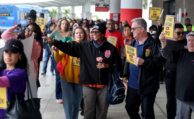 Protesters, including airport, nursing home and hotel workers, join for a press conference and candlelight vigil at Fort Lauderdale-Hollywood International Airport urging the Trump administration to extend Temporary Protected Status (TPS) for Haitian immigrants, Wednesday, Jan. 28, 2026. TPS for Haitian immigrants ends on Feb. 3, and organizers point to the U.S. government's own warnings about the dangers of traveling to Haiti. (Mike Stocker/South Florida Sun Sentinel)