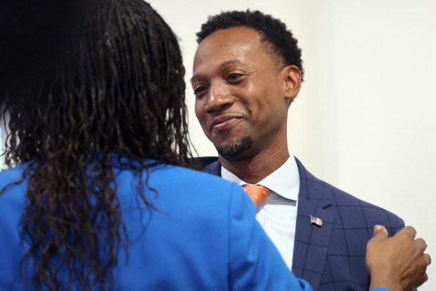 Torey Alston is embraced by a supporter after leaving a Broward College District Board of Trustees meeting at the College's Fort Lauderdale campus on Tuesday, Aug. 25, 2025. It was announced during the meeting that the College and Torey Alston had signed a mutual separation agreement. (Amy Beth Bennett/South Florida Sun Sentinel)