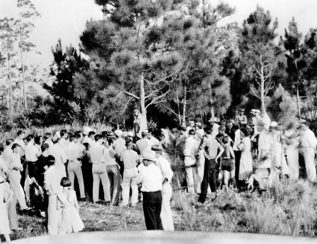 A crowd gathers to view the body of 32-year-old Rubin Stacy as he hangs from a tree in Fort Lauderdale, Fl., on July 19, 1935. Stacy was lynched by a mob of masked men who seized him from the custody of sheriff's deputies for allegedly attacking a white woman. (AP Photo)
