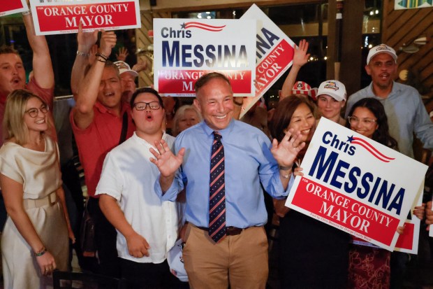 Orange County mayoral candidate Chris Messina celebrates his advancement to a November runoff with his family and supporters during an election night watch party at Grills Lakeside in Orlando on Tuesday. (Rich Pope/Orlando Sentinel)