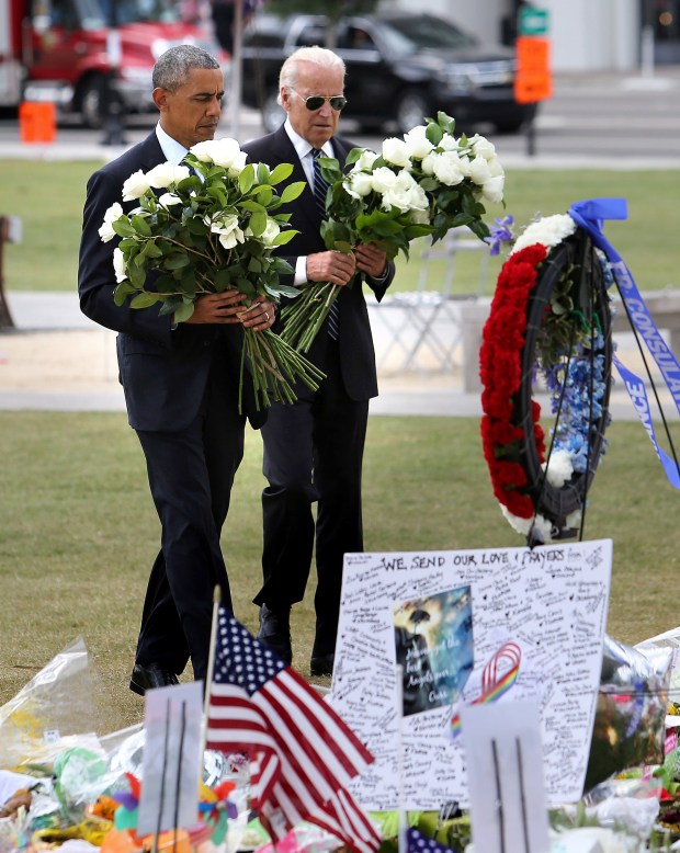 President Barack Obama and Vice President Joe Biden place flowers at the makeshift memorial at the Dr. Phillips Center for the Performing Arts in Orlando honoring the 49 killed in the Pulse nightclub massacre in June 2016. (Joe Burbank/Orlando Sentinel file)