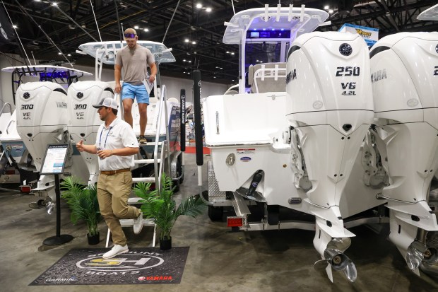 The 2025 Sea Hunt Gamefish on display by Ultimate Marine gets a look over by an attendee to the Orlando Boat Show in 2025. (Rich Pope/Orlando Sentinel)