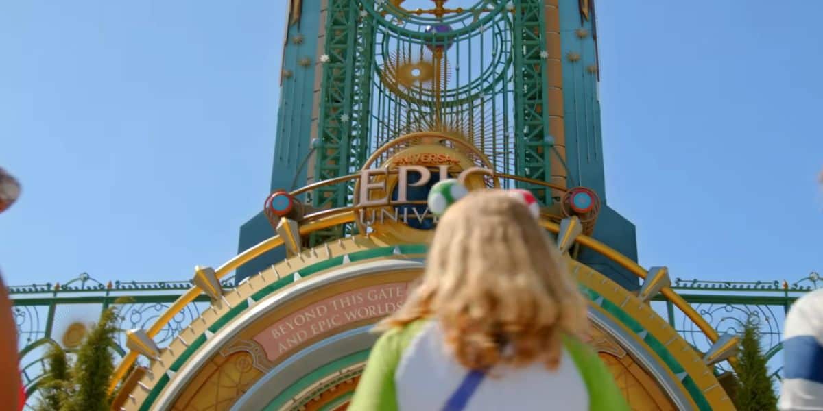 guest in front of entrance to Universal's Epic Universe theme park. Universal expansion vs Disney