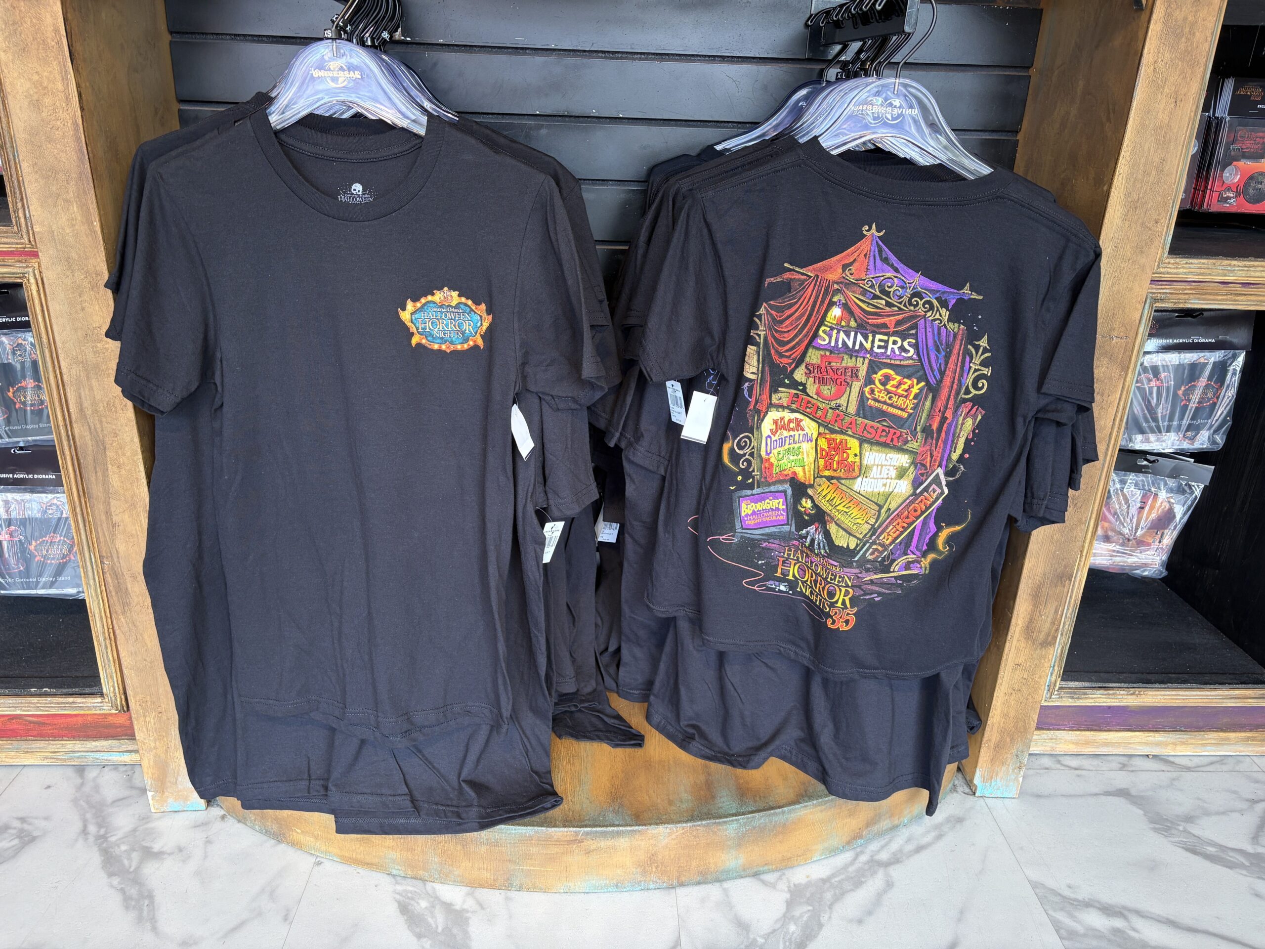 Halloween Horror Nights 35 merchandise featuring the event's logo and imagery from all of the houses is now available at Universal Orlando Resort. This merchandise can be found in Five & Dime in the Hollywood section of Universal Studios Florida.