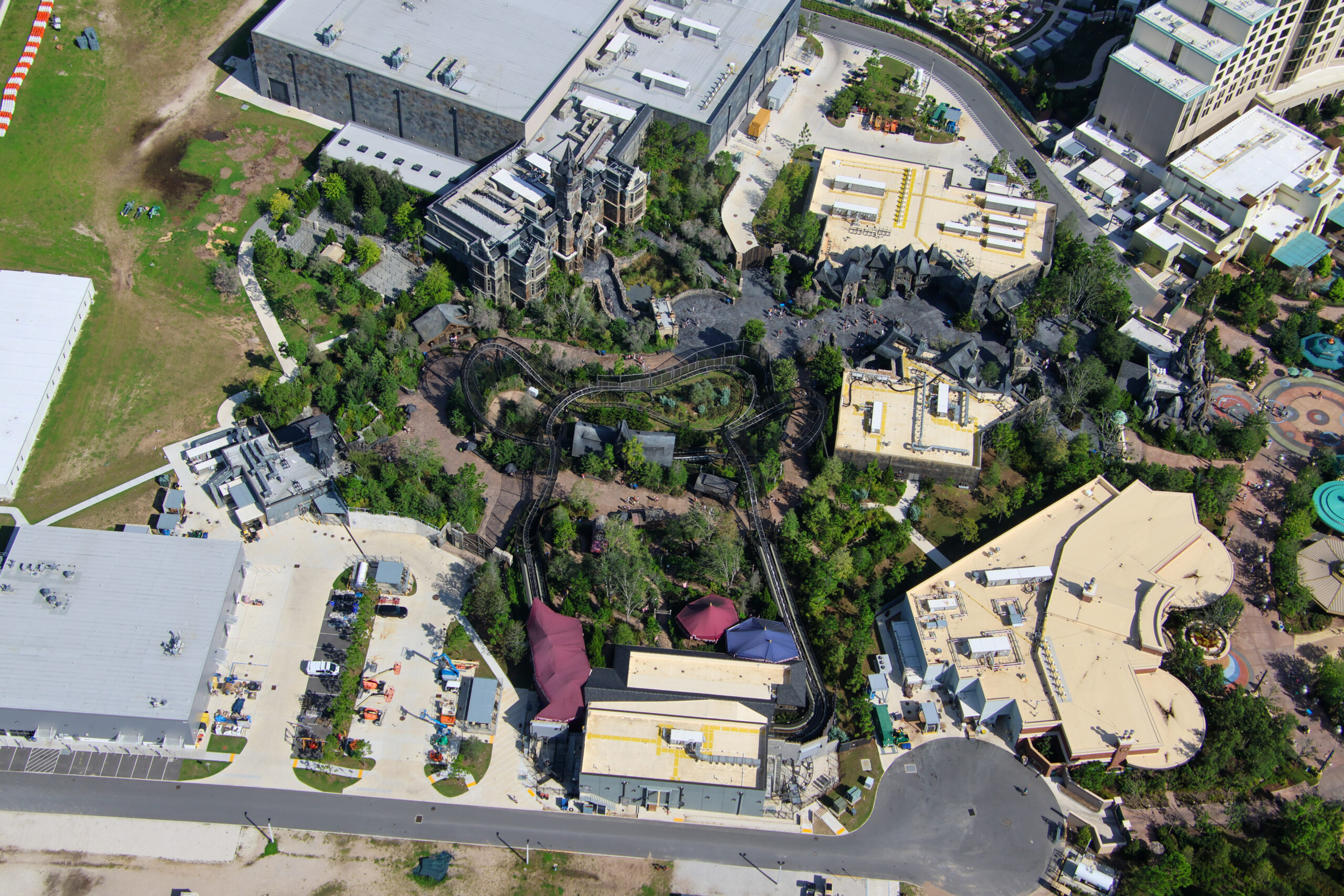 The cleared site is in the top left corner of the above photo, next to the Monsters Unchained show building. Dirt paths show where the tall trees used to be. They filled out the 
