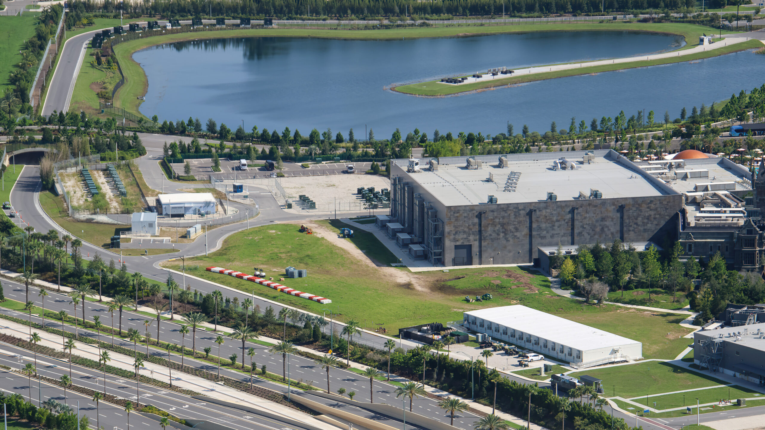 The cleared site is in the top left corner of the above photo, next to the Monsters Unchained show building. Dirt paths show where the tall trees used to be. They filled out the