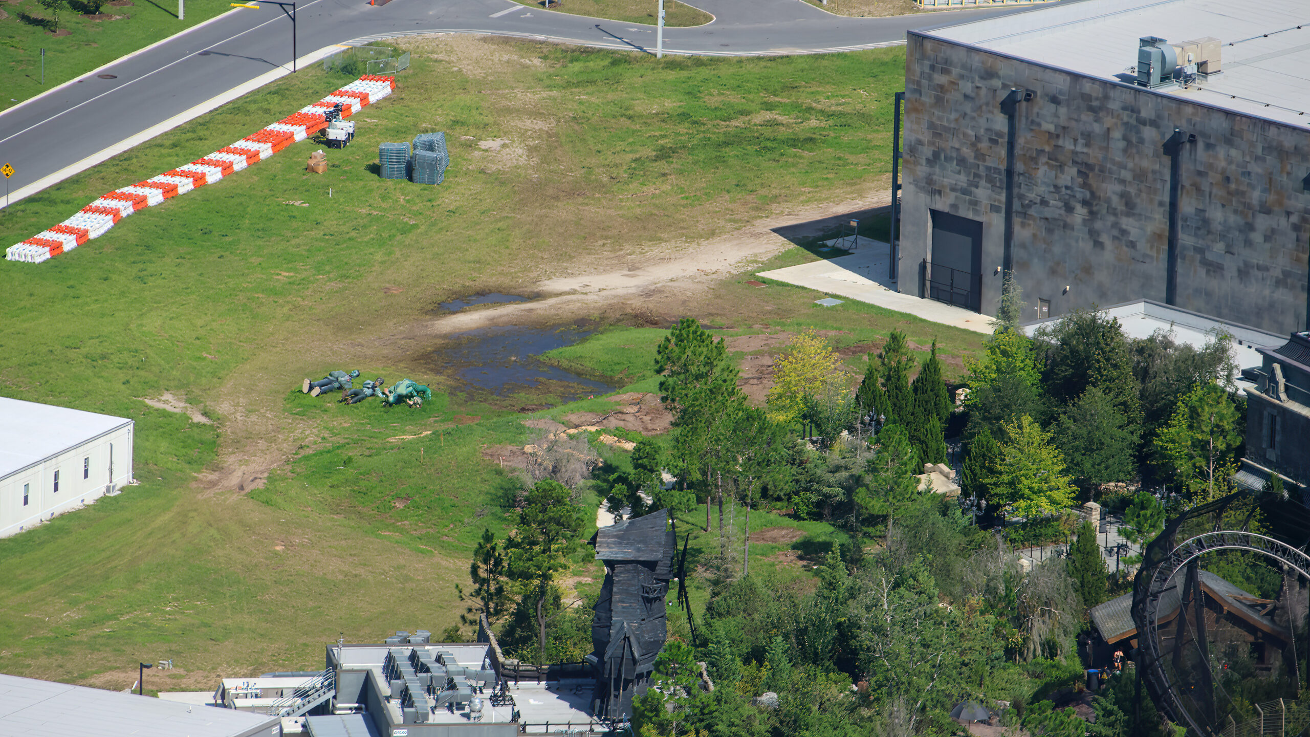 The cleared site is in the top left corner of the above photo, next to the Monsters Unchained show building. Dirt paths show where the tall trees used to be. They filled out the