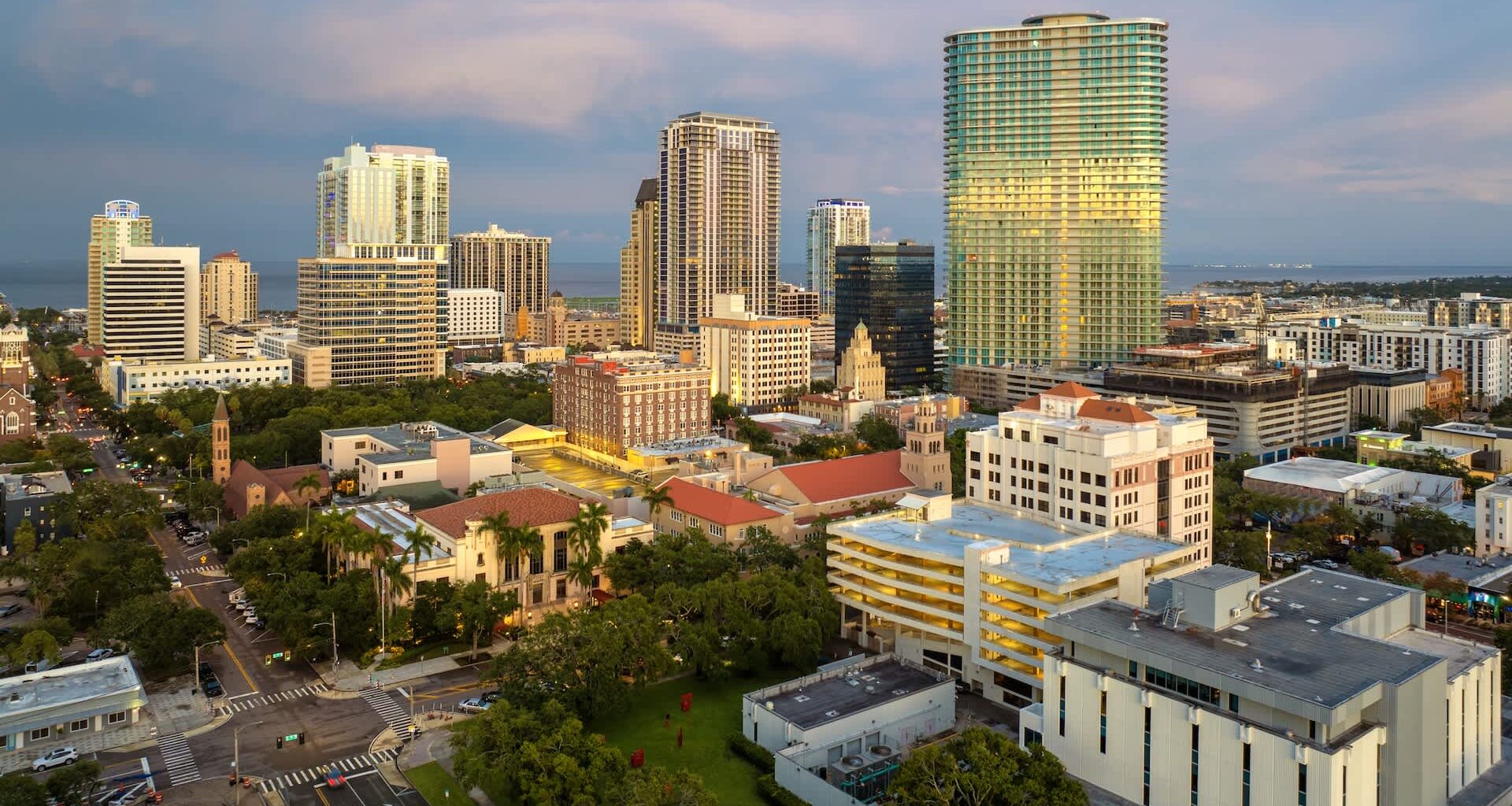 Aerial view of St. Petersburg, Florida, featuring modern skyscrapers, historic buildings, and green spaces.