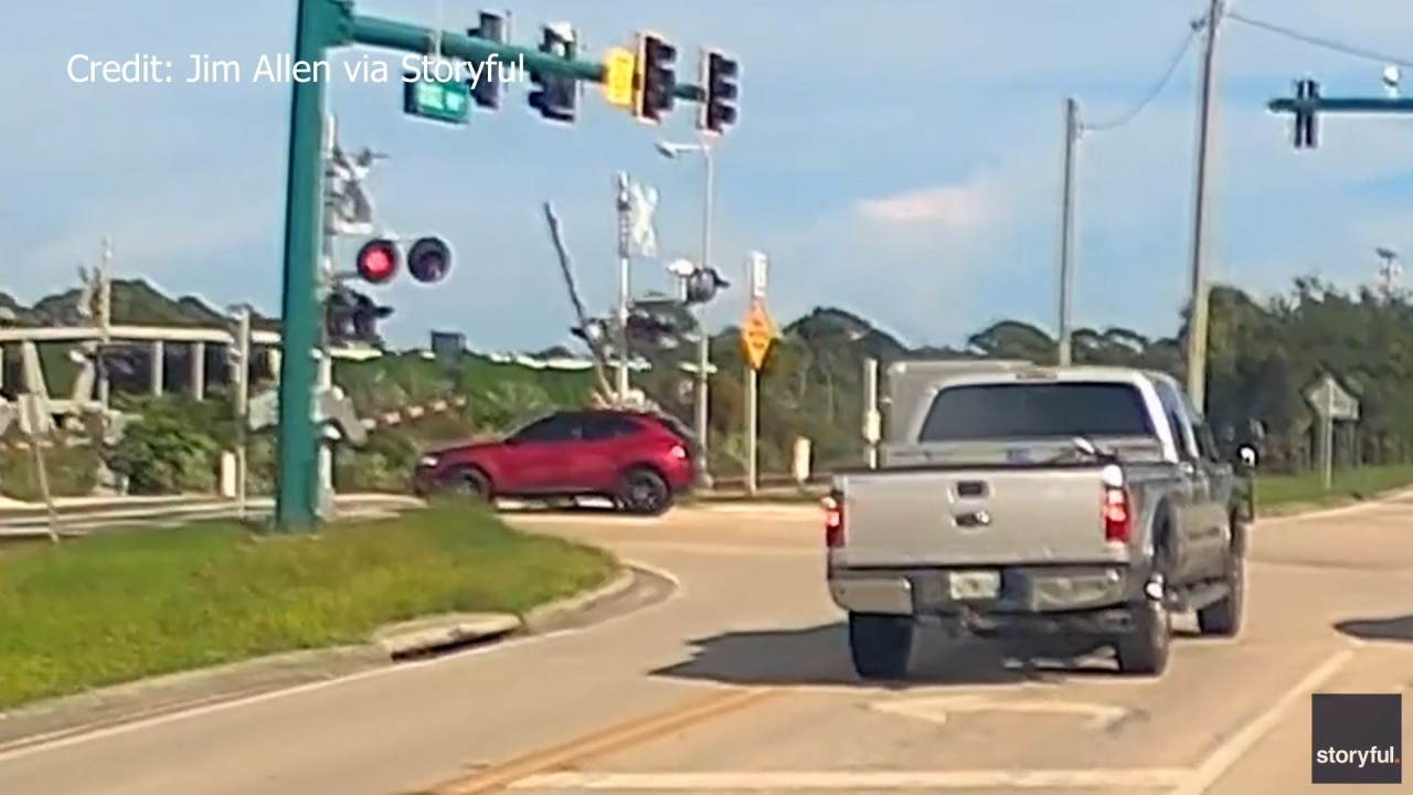 Man saves woman trapped on train tracks