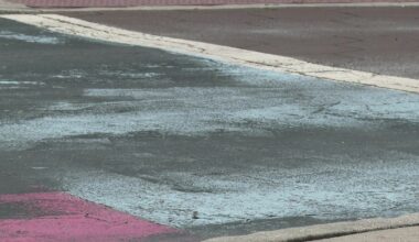 Covered St. Pete Pride mural peaks through black paint on Central Avenue