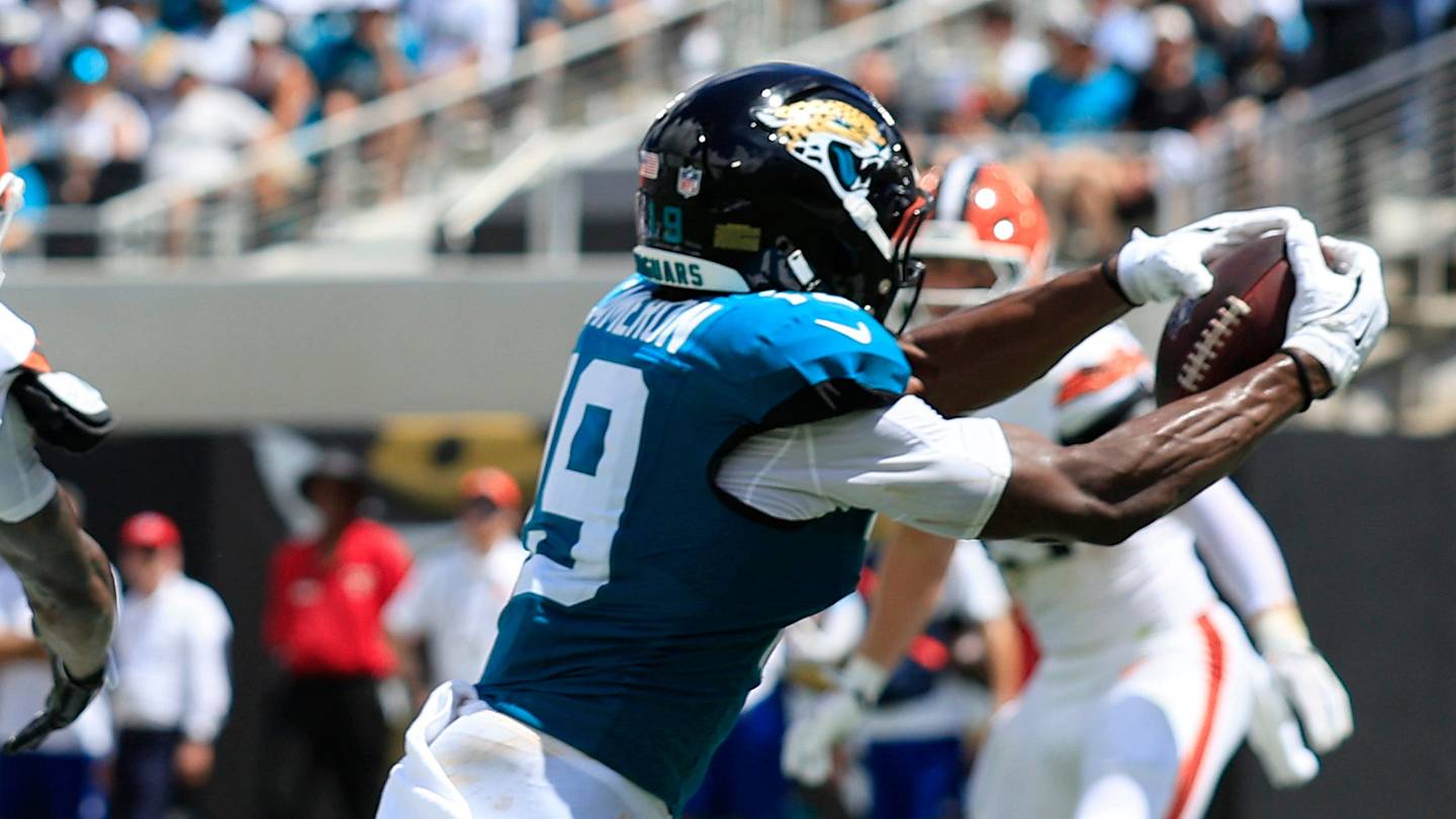 Jacksonville Jaguars wide receiver Josh Cameron (19) hauls in a touchdown reception against Cleveland Browns cornerback Denzel Ward (21) during the first quarter of an NFL football matchup at EverBank Stadium on Sunday, Sept. 13, 2026, in Jacksonville, Fla. The Jaguars defeated the Browns 34-10.