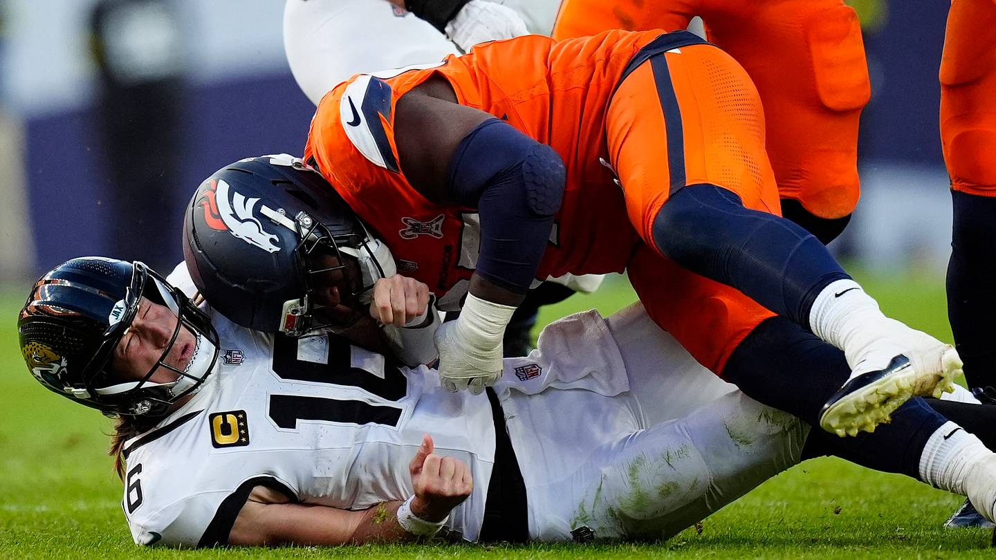 Dec 21, 2025; Denver, Colorado, USA; Denver Broncos defensive tackle Malcolm Roach (97) hits Jacksonville Jaguars quarterback Trevor Lawrence (16) during the second  half at Empower Field at Mile High. Mandatory Credit: Ron Chenoy-Imagn Images