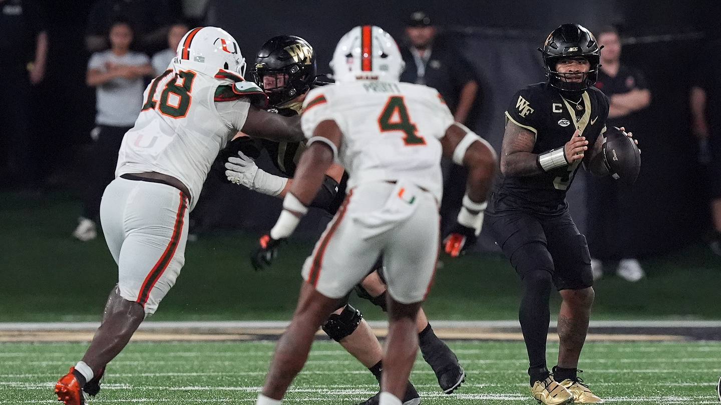 Sep 18, 2026; Winston-Salem, North Carolina, USA;  Wake Forest Demon Deacons quarterback Gio Lopez (3) looks to pass pressured by Miami (FL) Hurricanes defensive lineman Armondo Blount (18) and  linebacker Cameron Pruitt (4) during the second half at Allegacy Federal Credit Union Stadium.  Mandatory Credit: Jim Dedmon-Imagn Images