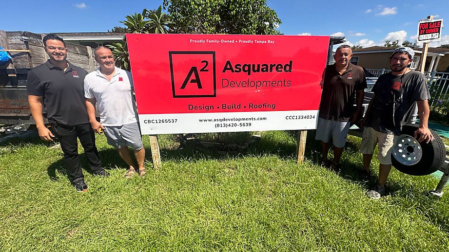 Allan Nunez (left) with his father, uncle and an employee of Asquared Developments, at a site where a home is in its final stages of construction. (Spectrum News)
