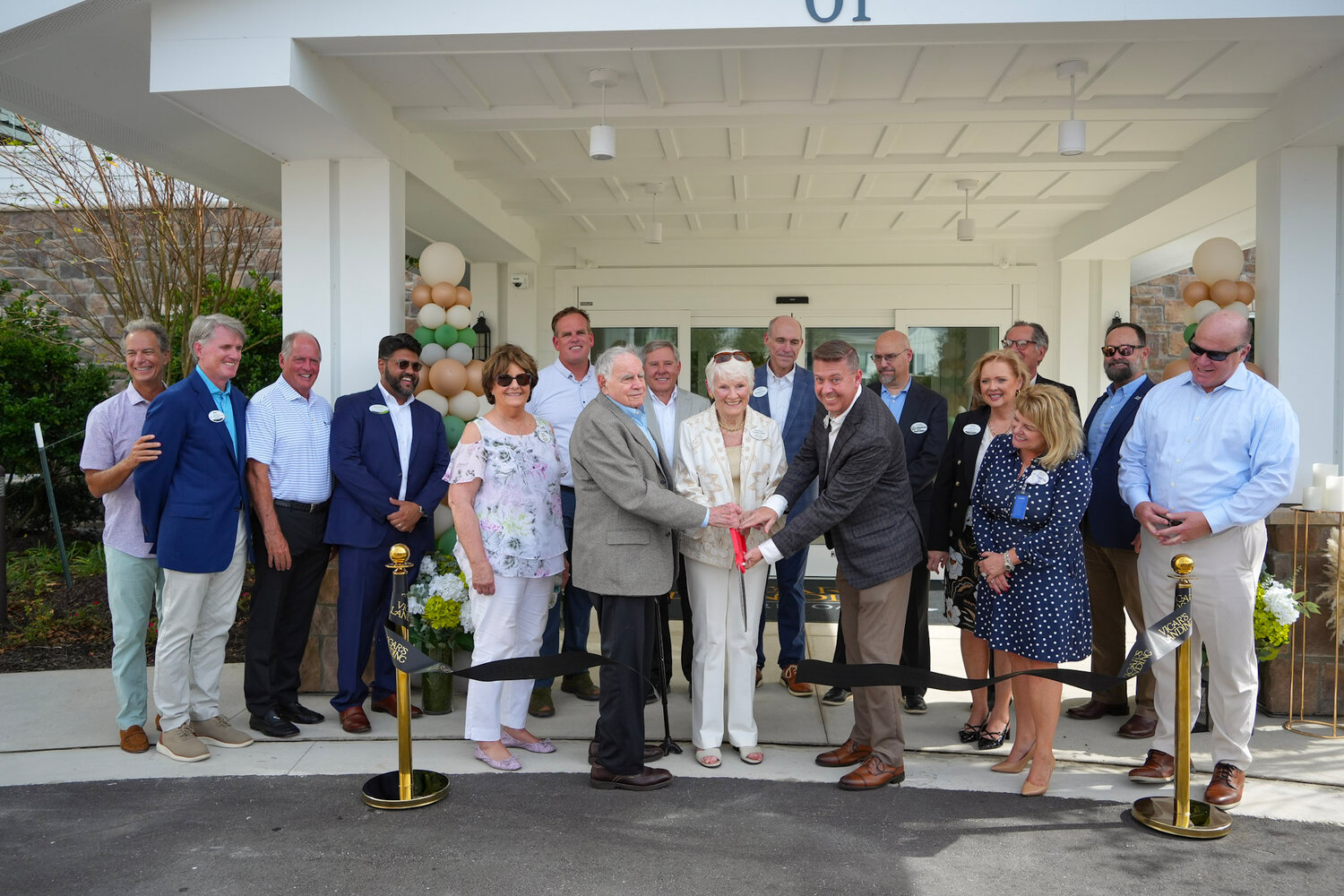 Vicar&rsquo;s Landing staff and guests cutting the ribbon to celebrate the expansion.