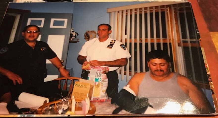 Fellow officers visit Chuck Diaz, pictured with broken right arm in cast.