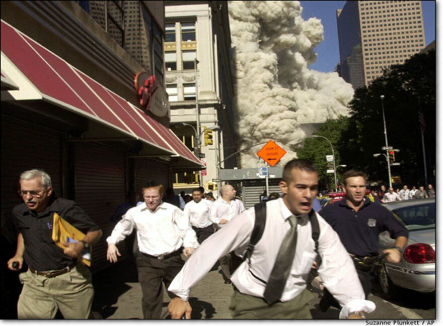 New Yorkers flee dust cloud generated as South Tower collapsed.