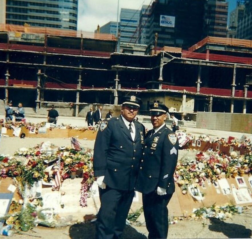 Chuck Diaz picture in 'the pit' on first anniversary of 9/11 with Sergeant Perfecto Oyola, who dove under fire truck to escaped debris from South Tower.