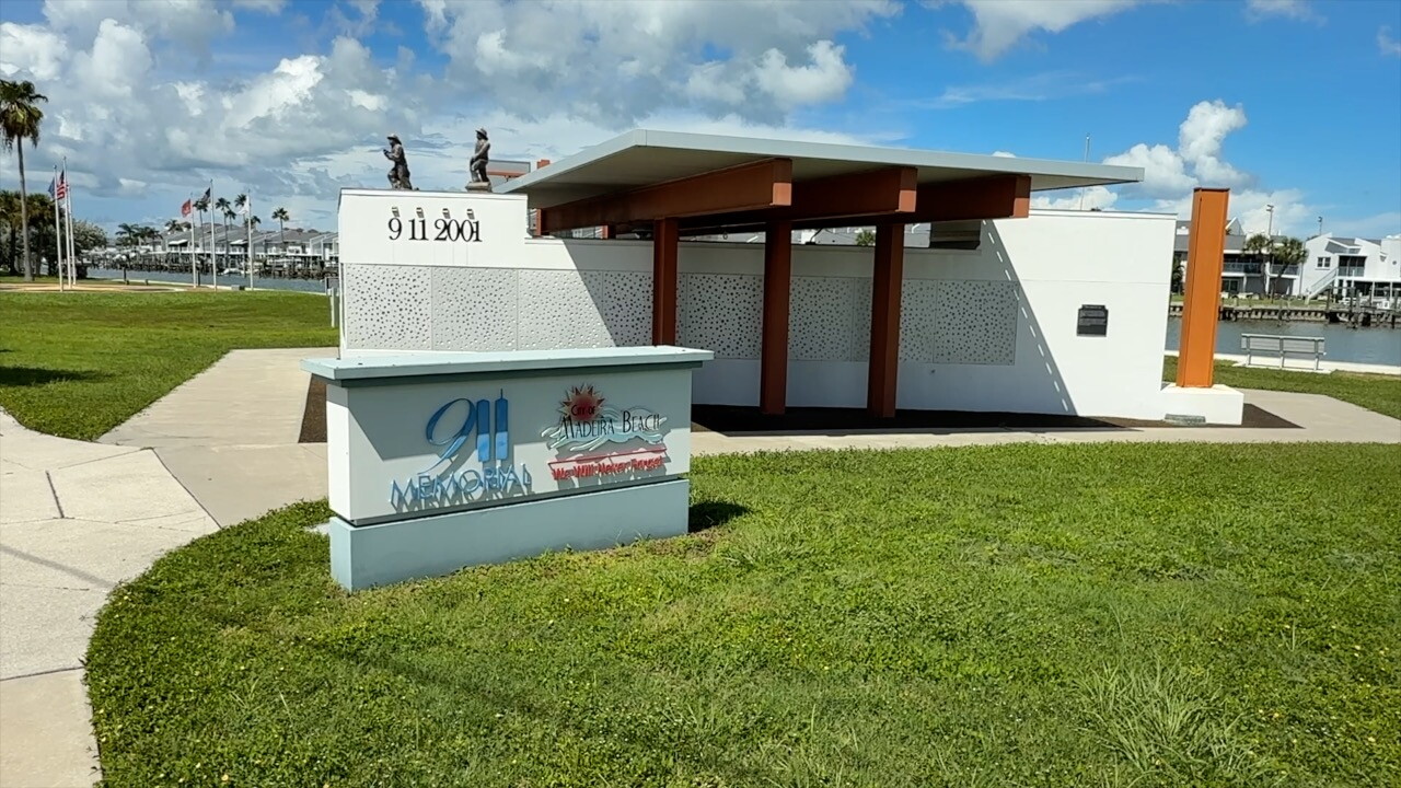 The 9/11 Memorial in Madeira Beach is located in Patriot Park. Panels with 3,000 holes represent the individual lives lost 25 years ago. The memorial features 3 steel beams with crash site coordinates written on each, a Pentagon-shaped layout, and an 800-pound piece of rubble from Ground Zero.