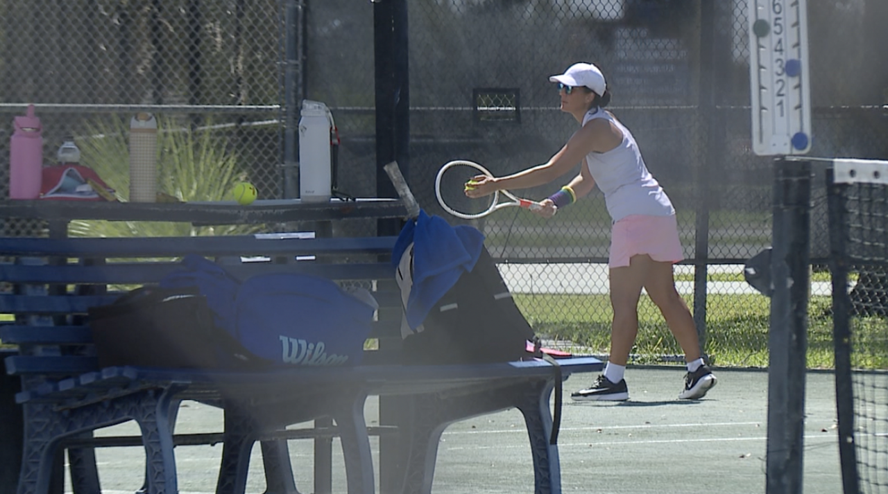 Woman playing tennis at HCC
