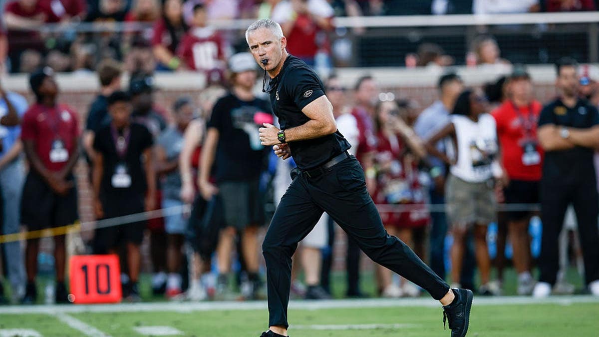 Mike Norvell stands on the field before a game at Doak S. Campbell Stadium.