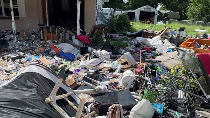 Shopping carts, furniture and piles of debris cover Apopka yard as neighbors ask: When will it be cleaned up?