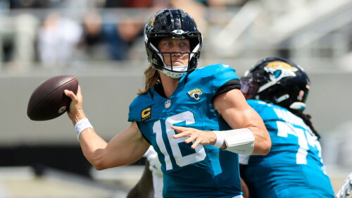 Jacksonville Jaguars quarterback Trevor Lawrence (16) throws a touchdown pass to wide receiver Parker Washington (11), not