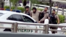 A man is taken into custody outside Miami International Airport on Sept. 23, 2026.