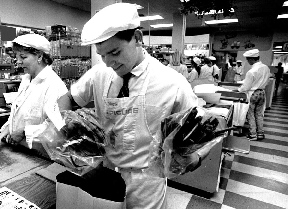 Ersun Yergin 17, bags groceries at Epicure Market. He had found and returned a bag containing $8,000 in cash and checks.
