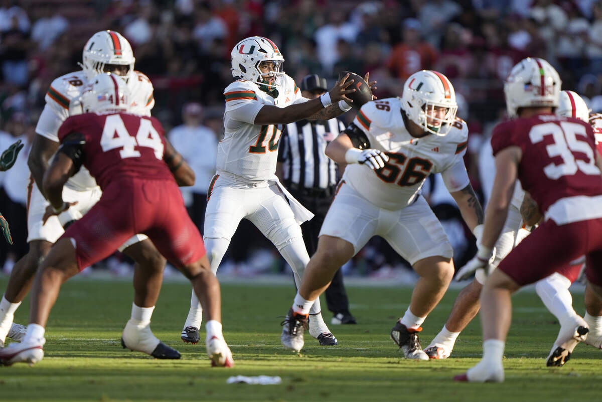 Sep 4, 2026; Stanford, California, USA; Miami Hurricanes quarterback Darian Mensah (10) takes the snap against the Stanford Cardinal during the first quarter at Stanford Stadium. Mandatory Credit: Stan Szeto-Imagn Images