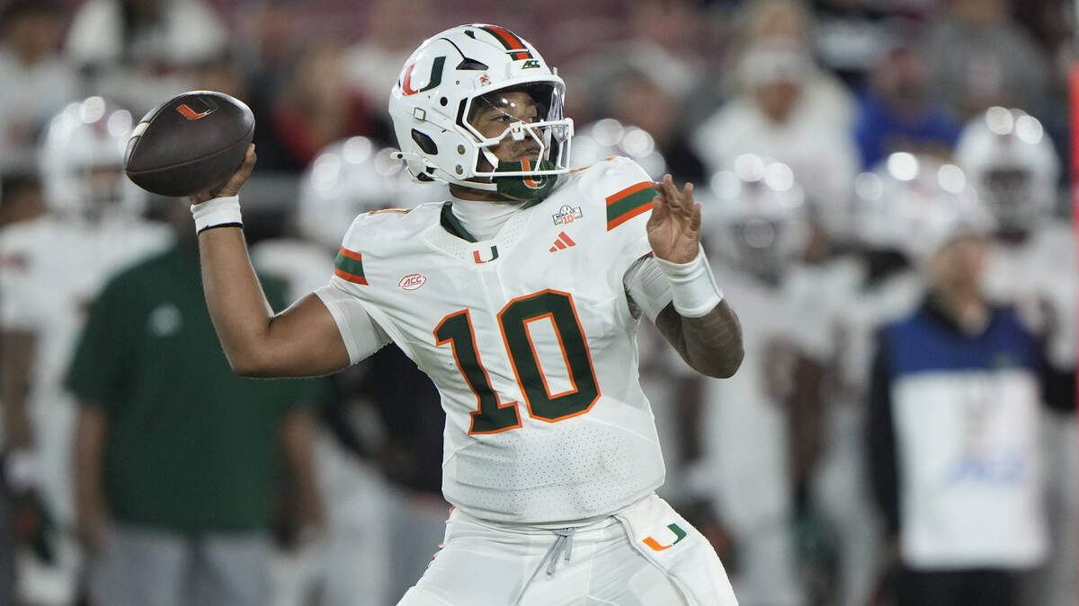 Sep 4, 2026; Stanford, California, USA; Miami Hurricanes quarterback Darian Mensah (10) stands in the pocket against the Stanford Cardinal during the third quarter at Stanford Stadium. Mandatory Credit: Stan Szeto-Imagn Images