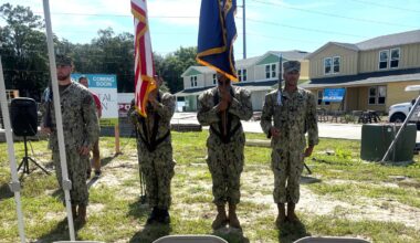 The flag being presented by servicemen from Naval Station Mayport.