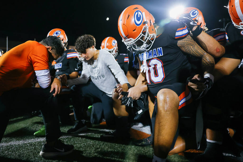 Bishop Gorman head coach Brent Browner prays the Our Father with his team after beating St. Joh ...