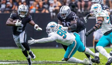 Raiders running back Ashton Jeanty (2) evades a tackle attempt by Miami Dolphins defensive end ...