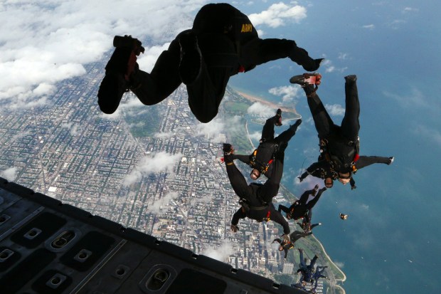 2016: Members of the Army Golden Knights and the Navy Leap Frogs parachute teams jump from a C-130 Hercules over North Avenue Beach as they perform in the annual Chicago Air and Water Show. (Anthony Souffle/Chicago Tribune)